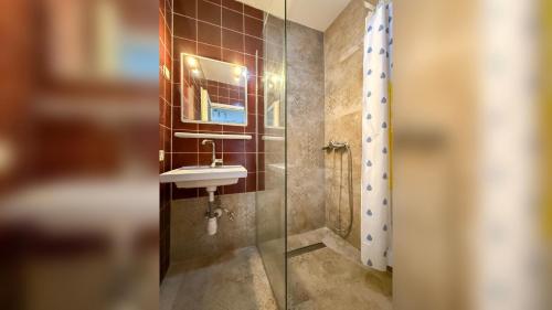 a bathroom with a sink and a glass shower at Lighthouse in Vodice