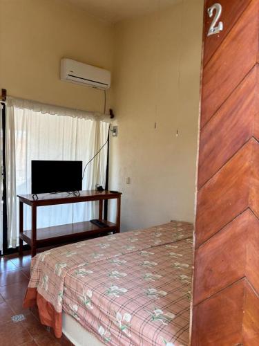 a bedroom with a bed and a desk in a room at Amueblados el sol in Barrio Nuevo