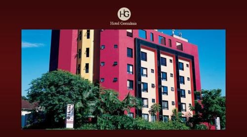 a large building with red and white at Hotel Germânia in Joinville