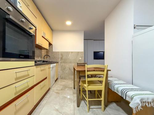a kitchen with a table and a chair in it at Lighthouse in Vodice
