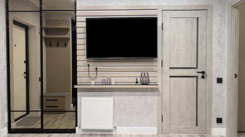 a bathroom with a sink and a tv on the wall at Best Couple's Getaway, Netflix! in Chişinău