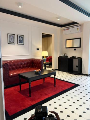 a living room with a couch and a table at Hotel Bengal Kutir in Rāiganj