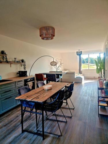 a living room with a wooden table and chairs at Sonsbeek city apartment "De Merel" in Arnhem