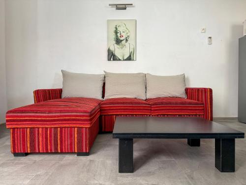 a red couch and a coffee table in a room at Lighthouse in Vodice