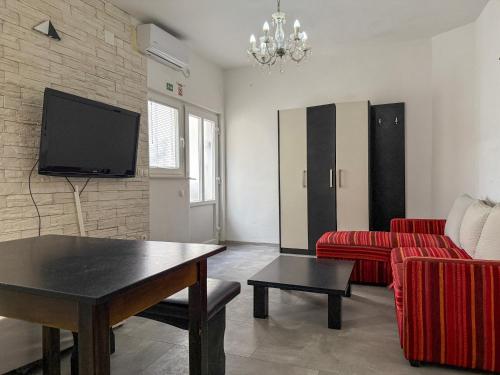 a living room with a couch and a table and a tv at Lighthouse in Vodice