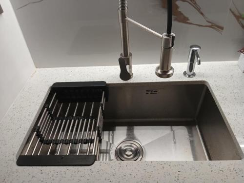 a kitchen sink with a faucet on a counter at MD Suite by Seawind in Davao City