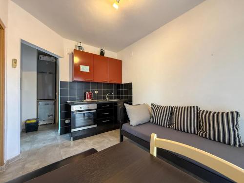 a living room with a couch and a kitchen at Lighthouse in Vodice