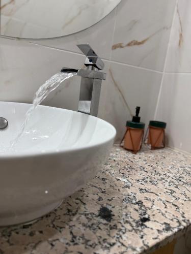 a bathroom sink with water coming out of it at Ciel&Azur in Sidi Ifni