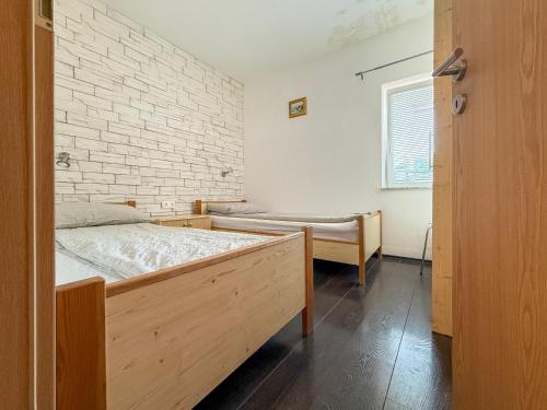 a bedroom with a bed and a brick wall at Lighthouse in Vodice