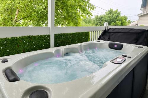 a jacuzzi tub sitting on top of a porch at The Coziest - Hot Tub - EV Chrger & Free Parking in Quebec City