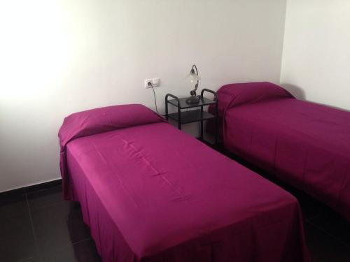 En eller flere senge i et værelse på Áticos Puerta Del Sol