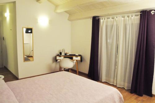 a bedroom with a bed and a table and a mirror at Da Oreste Affittacamere in Fara San Martino