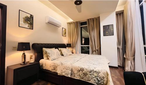 a bedroom with a bed and a window at Elysium Retreat Facing Centaurus Mall Islamabaad in Islamabad