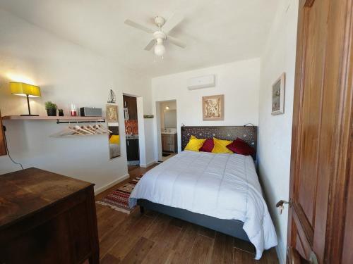 une chambre avec un lit et un ventilateur de plafond dans l'établissement Los Nopalitos 2 - Estudio chulísimo súper equipado a 3,5km de Carboneras, à El Llano de Don Antonio