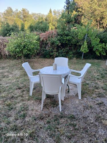 two chairs and a white table and chairs at Radovici Family House in Tivat