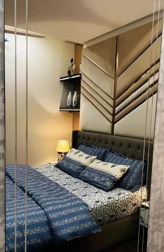 a bedroom with a bed with a glass wall at Elysium Retreat Facing Centaurus Mall Islamabaad in Islamabad