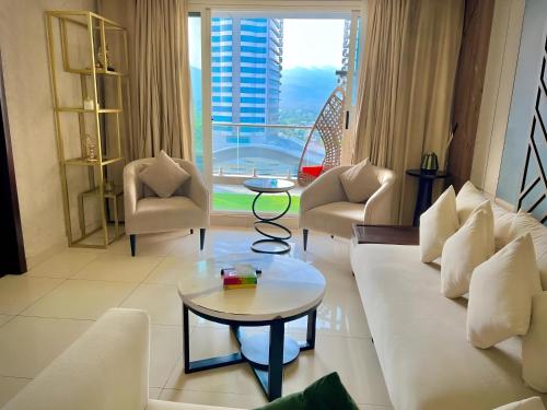 a living room with a couch and chairs and a table at Elysium Retreat Facing Centaurus Mall Islamabaad in Islamabad