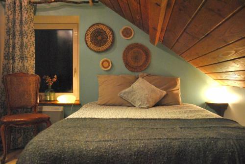 a bedroom with a large bed with a wooden ceiling at Lodge Les Rêveries de Charles in Plancher-les-Mines