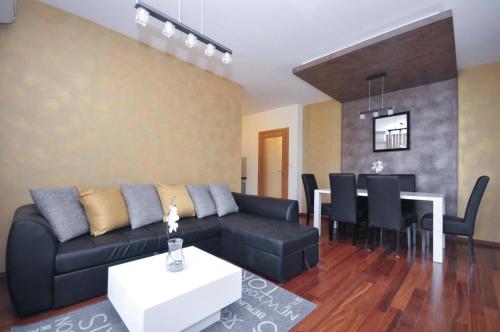 a living room with a couch and a table at Seaside Apartments Petrovac in Petrovac na Moru