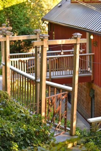a wooden fence next to a house at Salishan Tree House Suite in Cowichan Bay