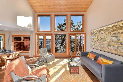 a living room with a couch and chairs and a table at Salishan Tree House Suite in Cowichan Bay