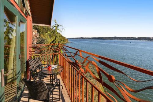 a balcony of a house with a table and chairs at Salishan Tree House Suite in Cowichan Bay