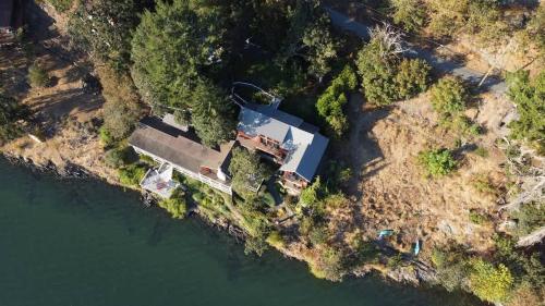 an aerial view of a house on the water at Salishan Tree House Suite in Cowichan Bay