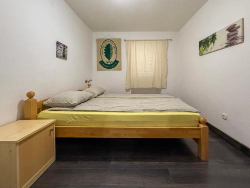 a small bedroom with a bed and a window at Lighthouse in Vodice