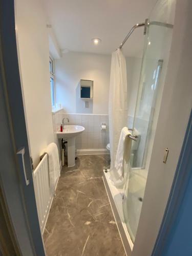 a bathroom with a shower and a sink at Modern 3 Bed Bromley, Chislehurst House - with parking in Chislehurst