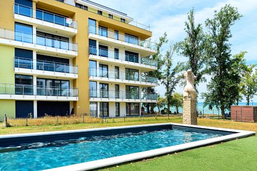 a building with a swimming pool in front of a building at Karolina - Winter Holidays in Siófok