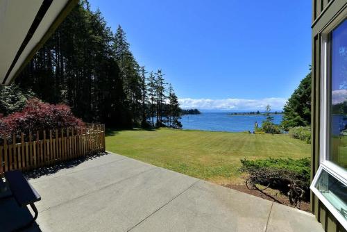 a view of the ocean from a porch of a house at Pacific Coast Beach House in Sooke