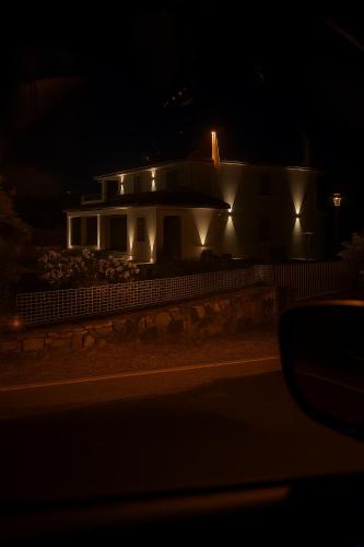 a house lit up at night at Le dune relax con cucina & piscina in San Teodoro