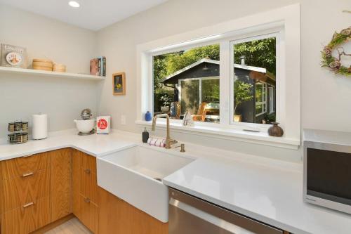 a kitchen with a sink and a window at The Bayside Cottage in North Saanich