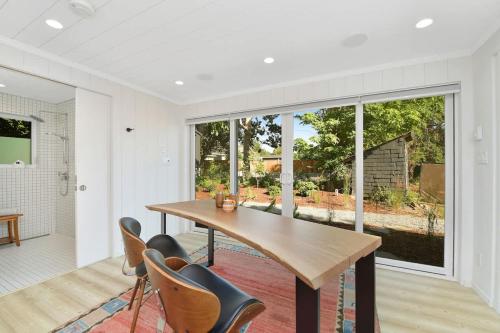 a dining room with a wooden table and chairs at The Bayside Cottage in North Saanich