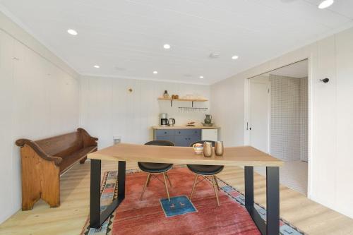 a dining room with a table and a couch at The Bayside Cottage in North Saanich