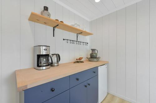 a kitchen with a counter with a coffee maker on it at The Bayside Cottage in North Saanich