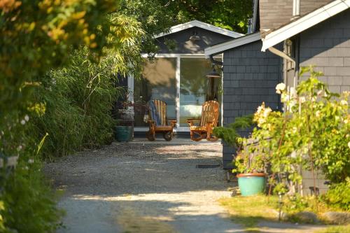 a porch of a house with chairs on it at The Bayside Cottage in North Saanich