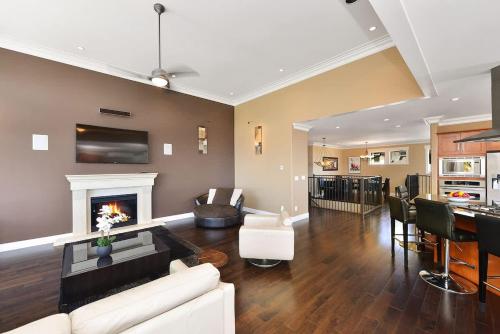 a living room with a couch and a fireplace at Nature's Gate Executive Estate in Victoria