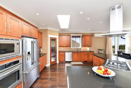 a kitchen with wooden cabinets and a bowl of fruit on a counter at Nature's Gate Executive Estate in Victoria