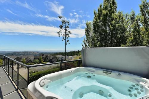 a bath tub sitting on top of a balcony at Nature's Gate Executive Estate in Victoria