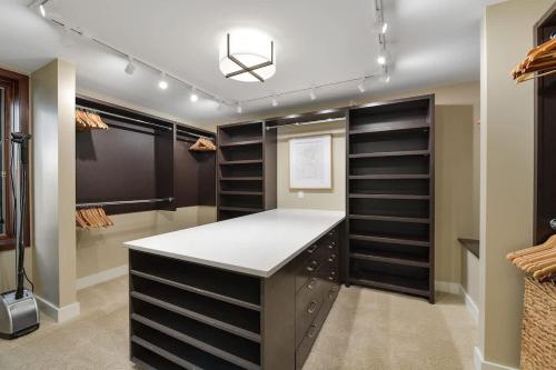 a walk in closet with black shelves at Island Luxury Oceanside Estate in Saanichton