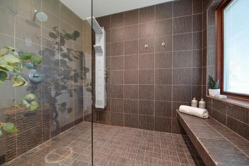 a shower with a glass door in a bathroom at Island Luxury Oceanside Estate in Saanichton
