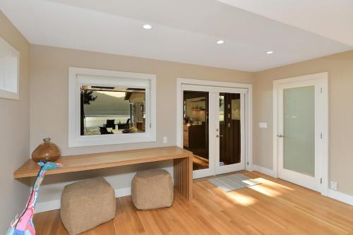 a living room with a table and two chairs at Island Luxury Oceanside Estate in Saanichton