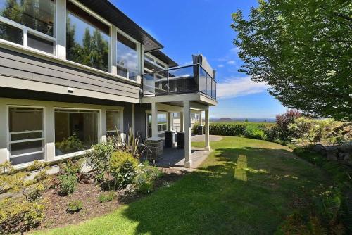a large house with a balcony and a yard at Nature's Gate Executive Estate in Victoria