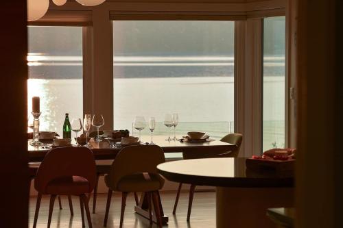 a dining room with a table and chairs and a window at Island Luxury Oceanside Estate in Saanichton