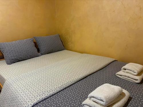 a bedroom with a bed with two towels on it at Apartmani Dimitrijevic in Kaludjerske Bare