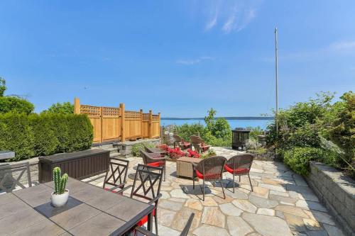 a patio with a table and chairs and the ocean at Gulf Island View Suite in Chemainus