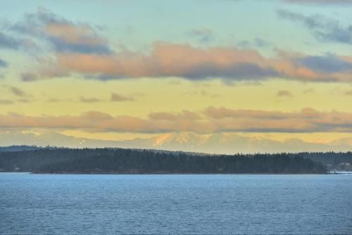 a large body of water with mountains in the background at Gulf Island View Suite in Chemainus