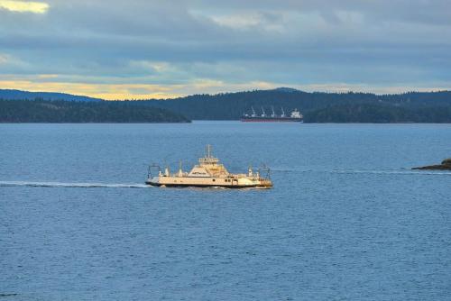 a boat in the middle of a large body of water at Gulf Island View Suite in Chemainus