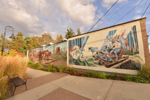 a mural on the side of a building with a bench at Gulf Island View Suite in Chemainus